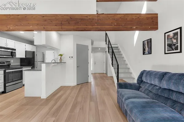 a living room with furniture and kitchen view