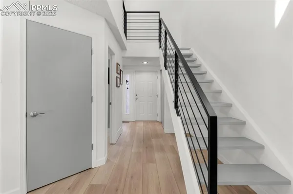 a view of a hallway with wooden floor and entryway