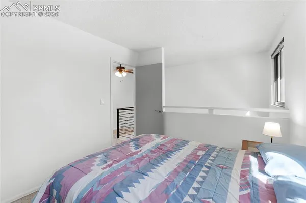 a bedroom with a bed and a lamp