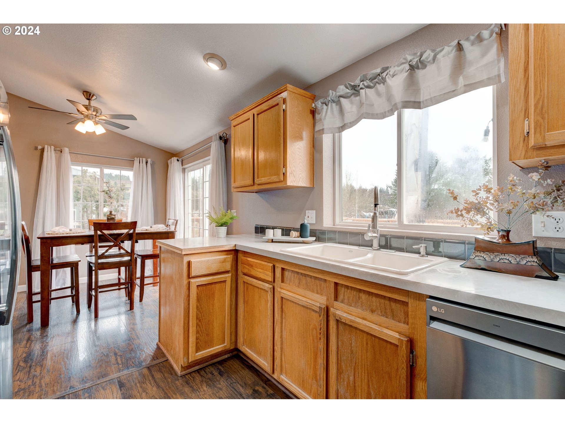 22120 Southwest Riggs Road Beaverton, OR 97078 - Photo 8 of 35 a kitchen with a sink window and cabinets