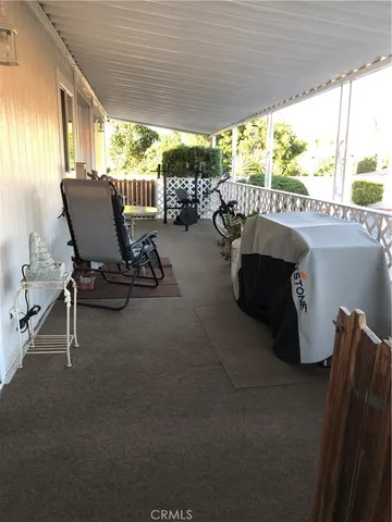 a view of a patio with chairs and a table