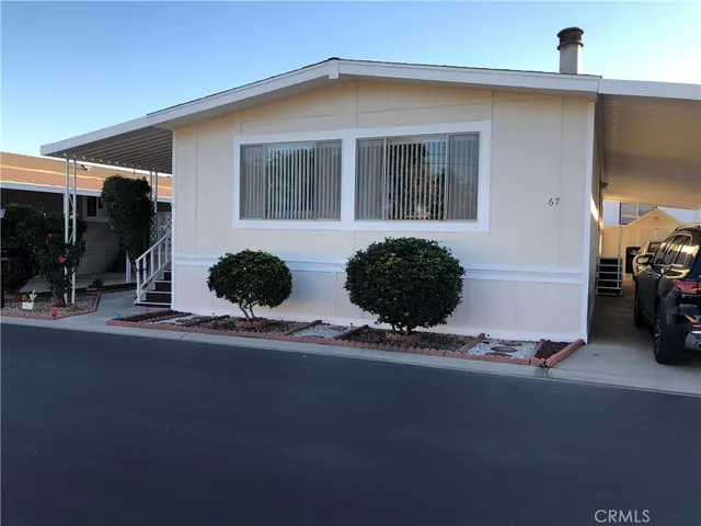 a front view of a house with lots of cars