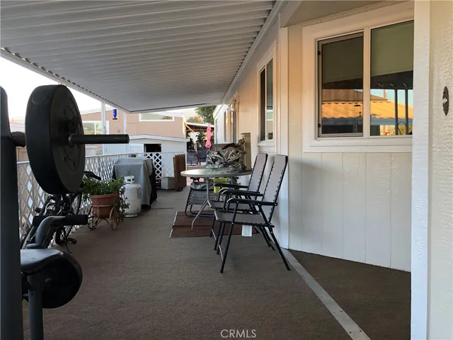 a view of a patio with table and chairs and potted plants
