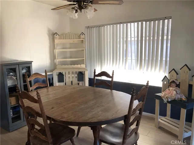 a view of a dining room with furniture and a potted plant