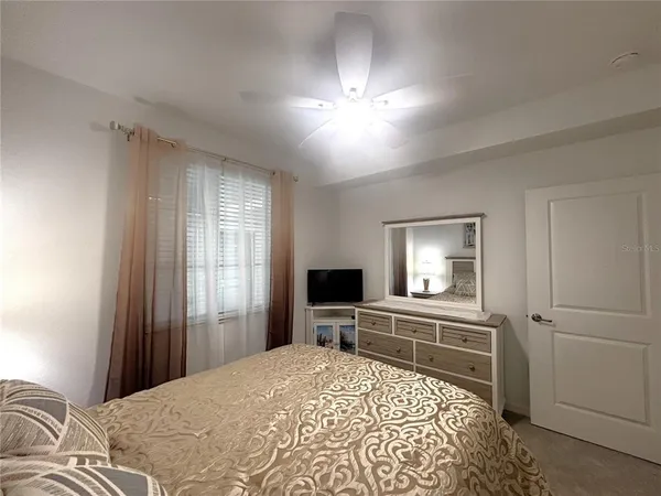 a bed room with a bed and a television