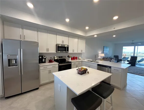 a kitchen with refrigerator a stove a sink dishwasher and a refrigerator with wooden floor