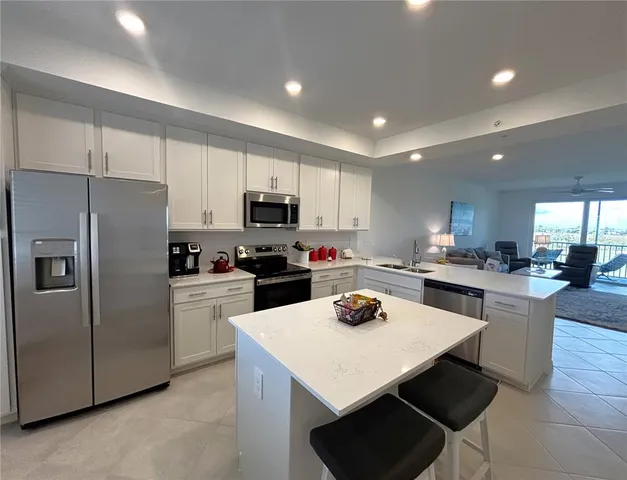 a kitchen with refrigerator a stove a sink dishwasher and a refrigerator with wooden floor