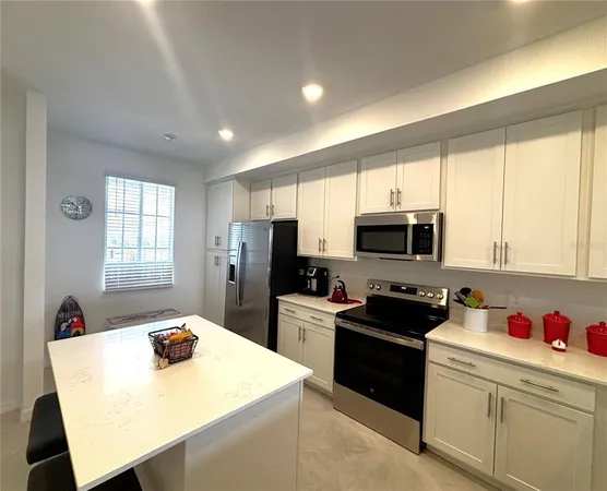 a kitchen with a sink a stove a refrigerator and a refrigerator