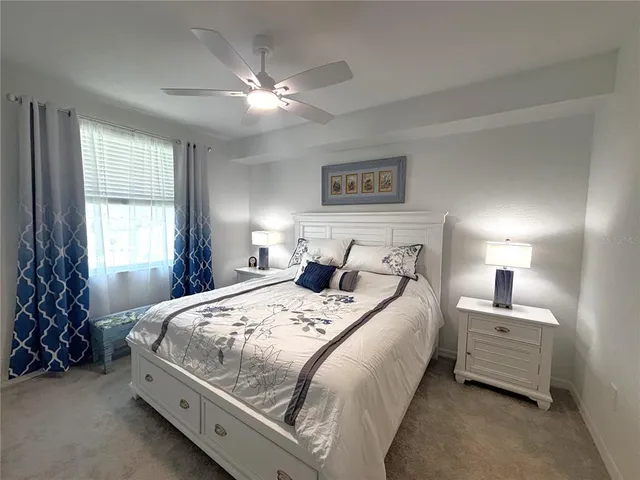 a bedroom with bed and a chandelier