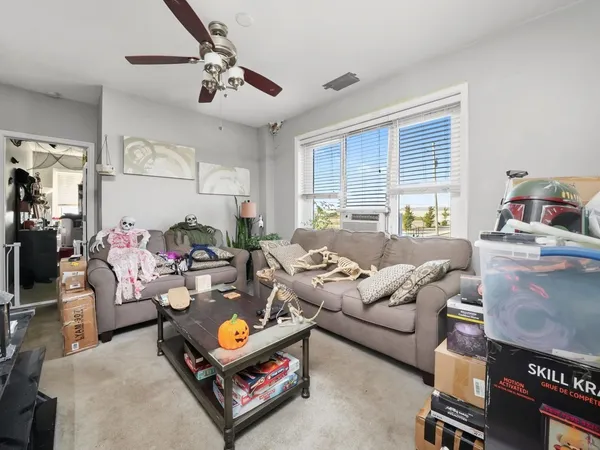 a living room with furniture and floor to ceiling window