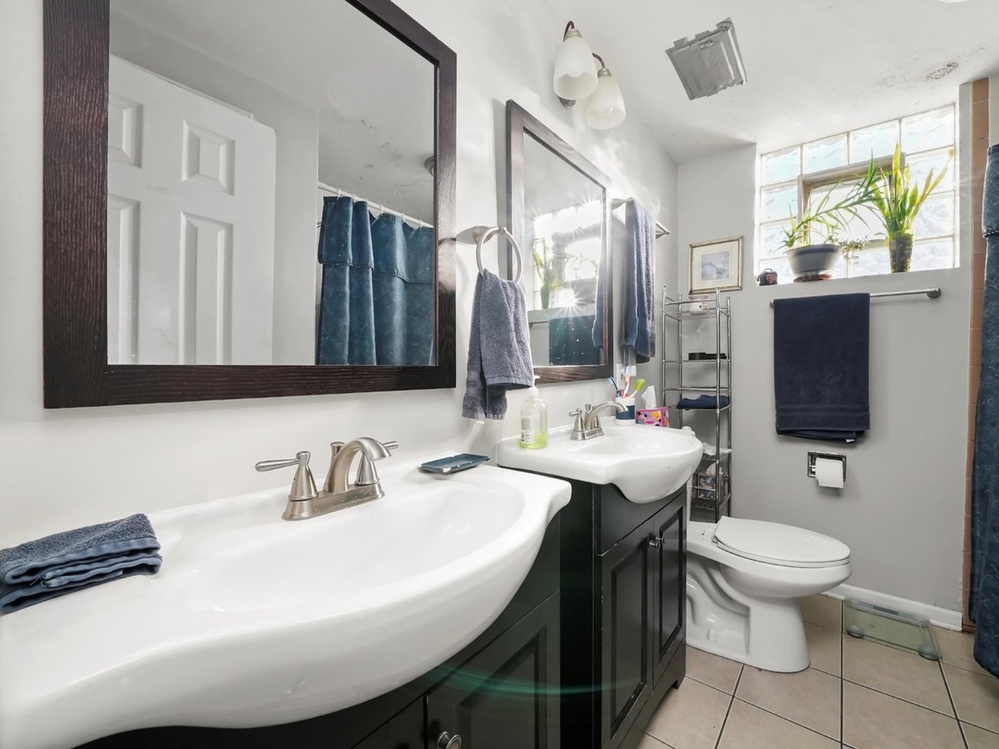 5758 West 65th Street Chicago, IL 60638 - Photo 27 of 33 a bathroom with a sink a toilet and mirror