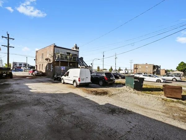 a view of a cars park in front of building