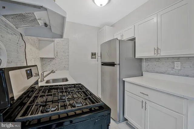 a kitchen with cabinets and a stove top oven