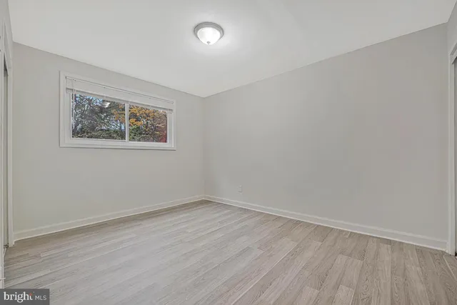 a view of an empty room and wooden floor