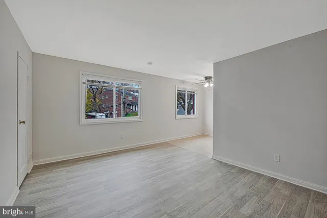 a view of an empty room with wooden floor