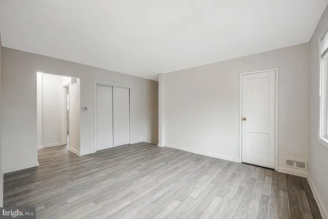 a view of a livingroom with wooden floor and a ceiling fan