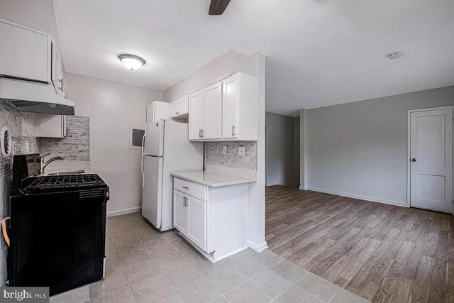 a kitchen with cabinets and appliances