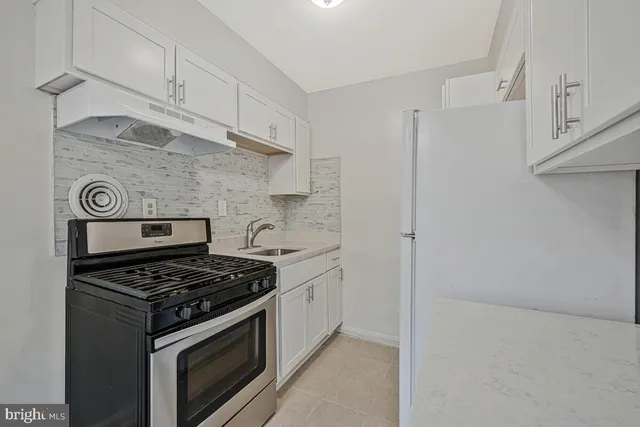 a kitchen with a refrigerator and a stove