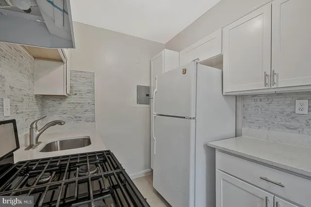 a kitchen with stainless steel appliances granite countertop a stove and a refrigerator