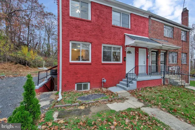 a front view of brick house with a yard