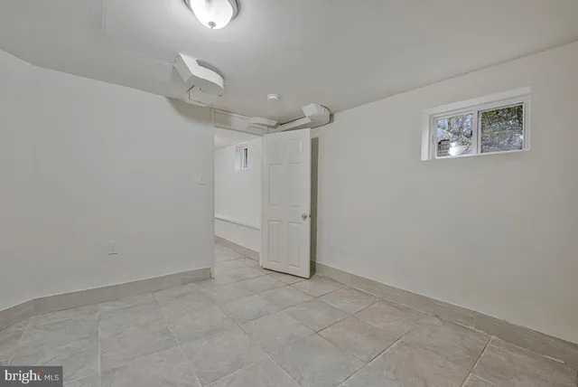 a white toilet sitting next to a bath tub