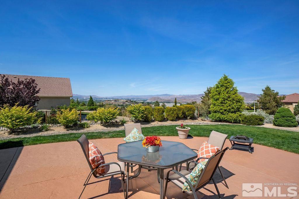 5649 North White Sands Road Reno, NV 89511 - Photo 4 of 36 a backyard of a house with a table and chairs