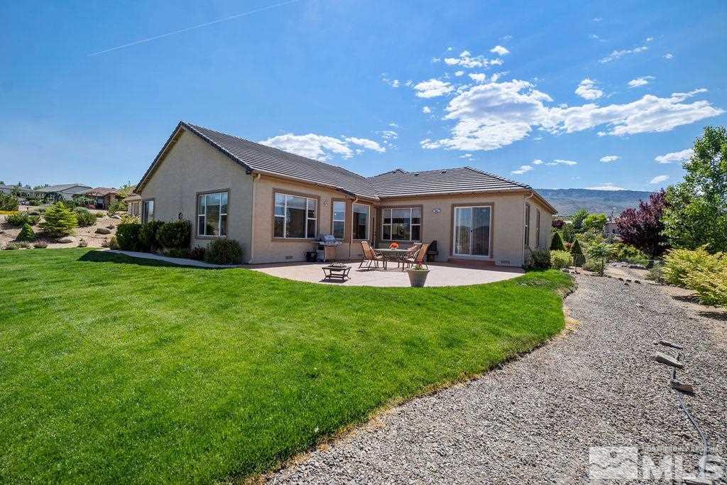 5649 North White Sands Road Reno, NV 89511 - Photo 5 of 36 a front view of house with a garden and patio