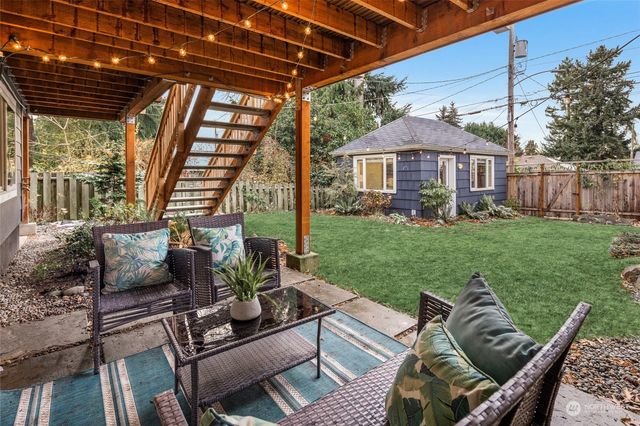 a view of a patio with couches chairs and a yard