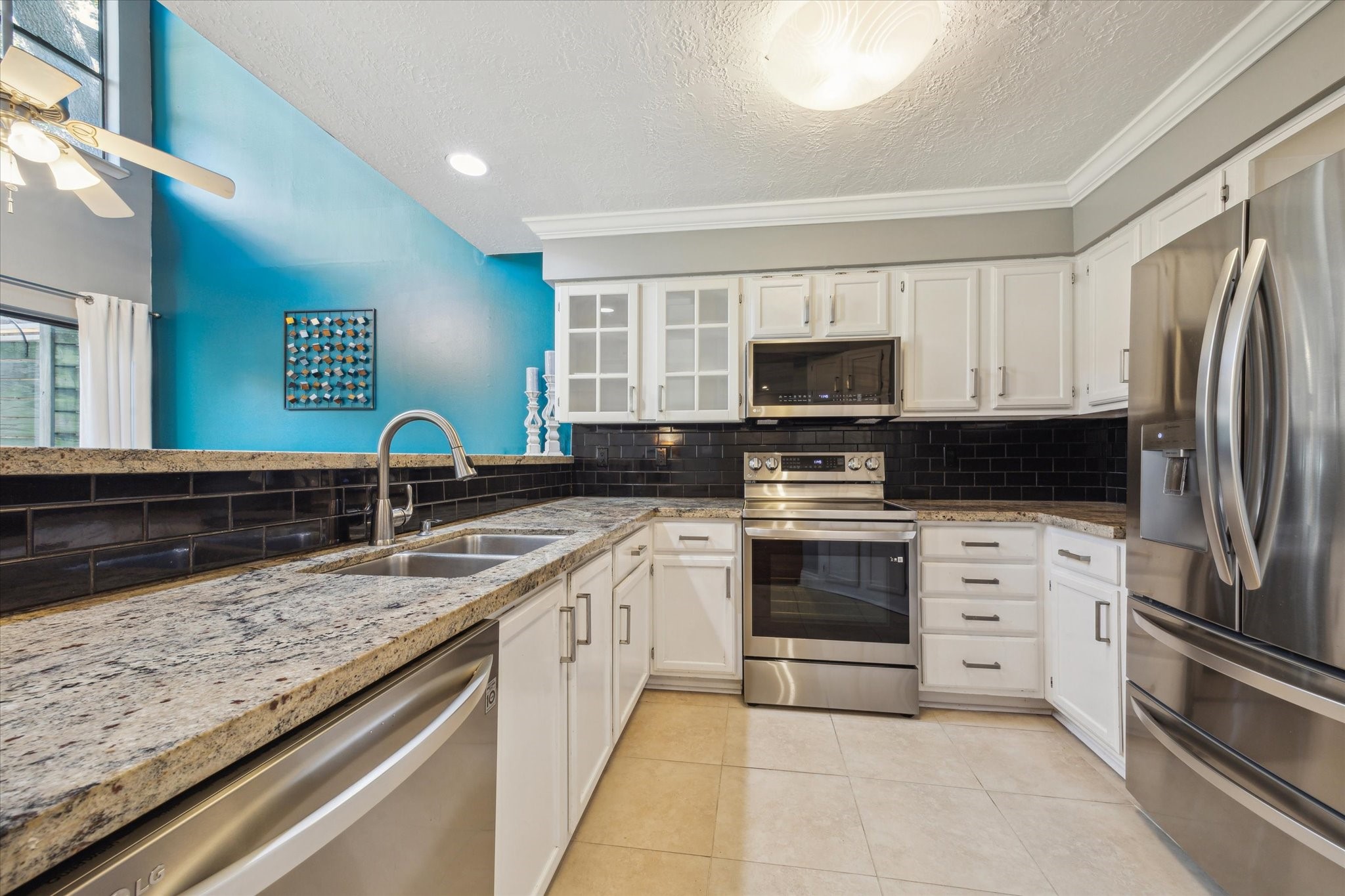 2107 Morgan Street Houston, TX 77006 - Photo 7 of 13 Updated kitchen featuring granite countertops, stainless appliances & abundant storage.
