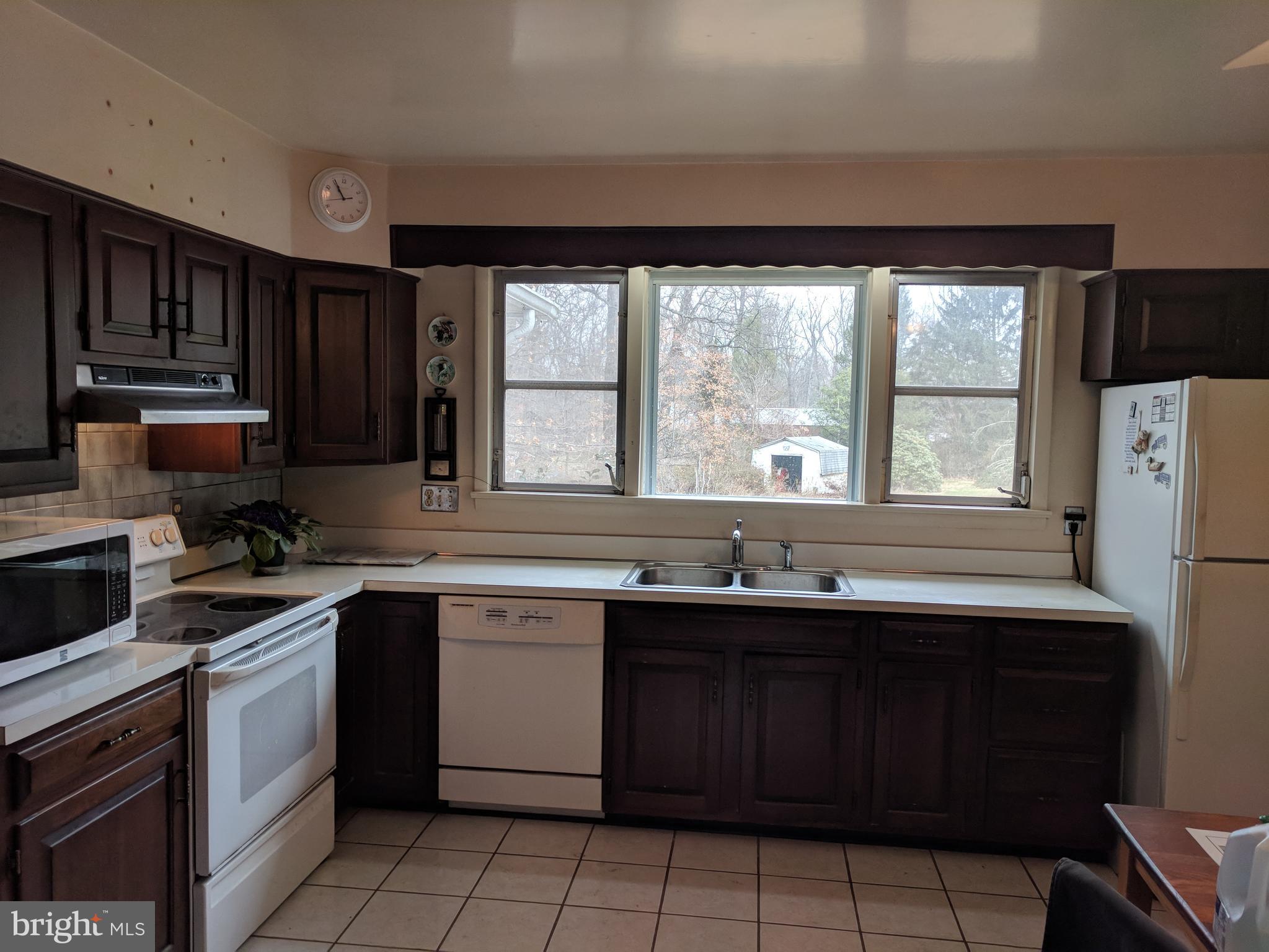 17332 Donora Road Silver Spring, MD 20905 - Photo 11 of 18 a kitchen with a sink stove and cabinets