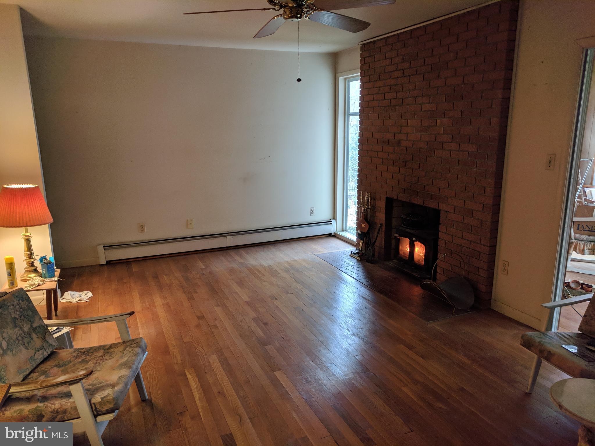 17332 Donora Road Silver Spring, MD 20905 - Photo 13 of 18 a view of an empty room with wooden floor and a fireplace