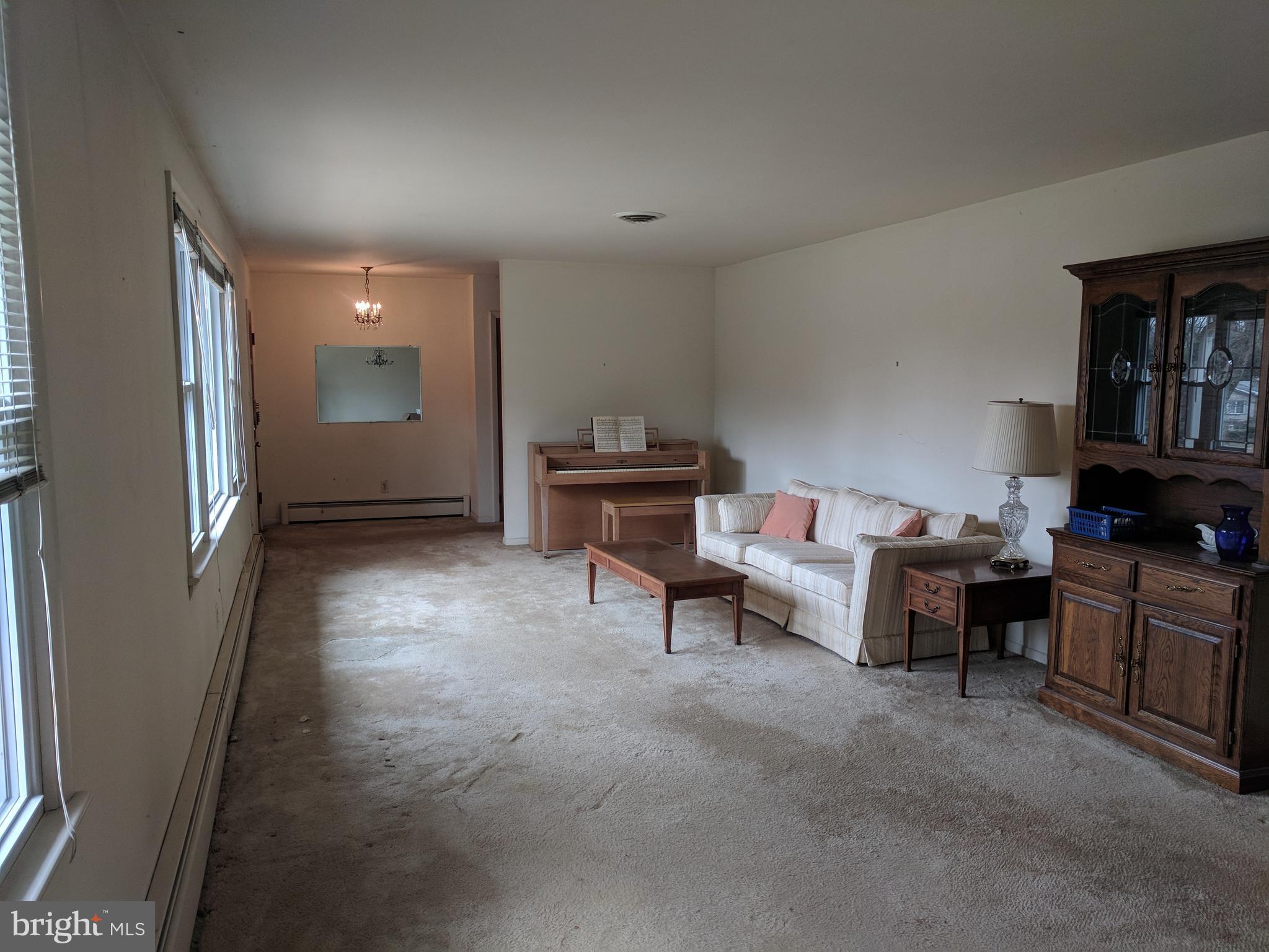 17332 Donora Road Silver Spring, MD 20905 - Photo 15 of 18 a living room with furniture and a piano