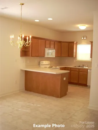 a kitchen with kitchen island a sink stainless steel appliances and cabinets