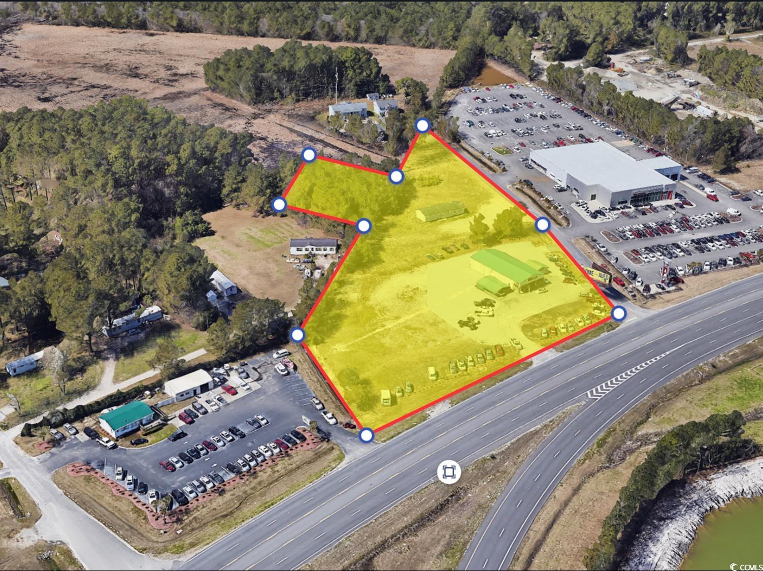 Aerial view of property and surrounding area featuring property parcel outlined
