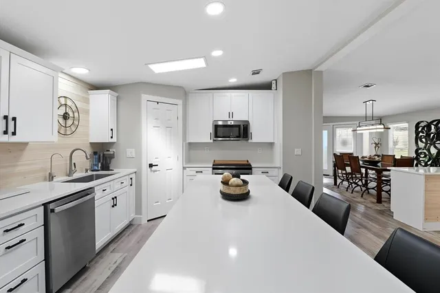 a kitchen with a sink stainless steel appliances and cabinets