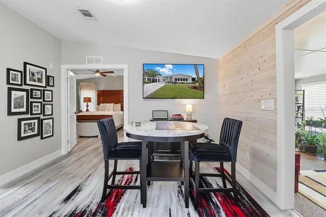a view of a dining room with furniture and wooden floor