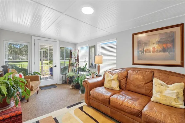 a blue couch sitting in a living room next to a window