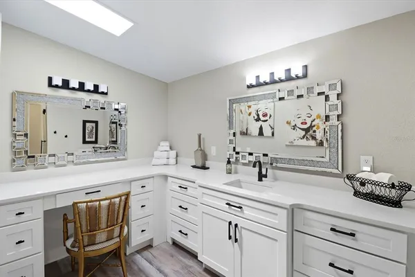 a bathroom with double vanity sink a mirror and bathtub