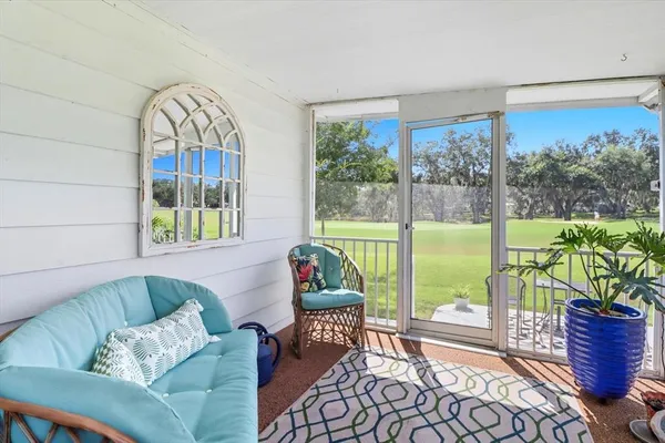 a living room with furniture and a floor to ceiling window