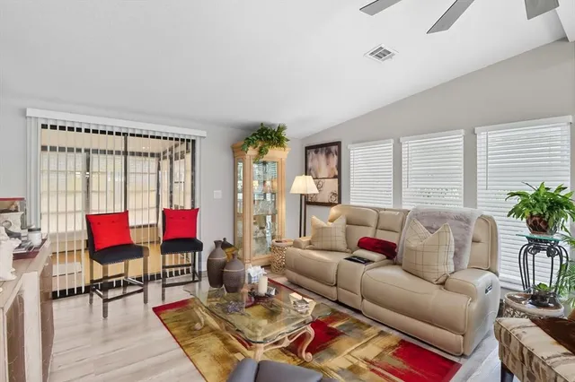 a living room with furniture a rug and a lamp