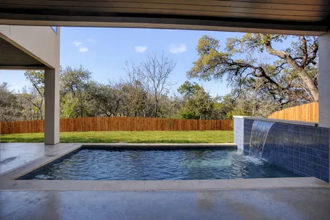 a view of swimming pool with a yard