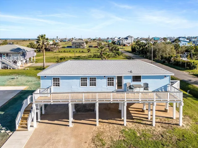 an aerial view of a house with a yard and garage