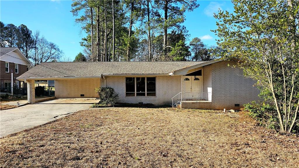 2418 Henderson Road Tucker, GA 30084 - Photo 1 of 1 a house with yard in front of it