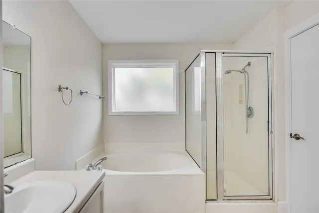 a bathroom with a shower and a sink