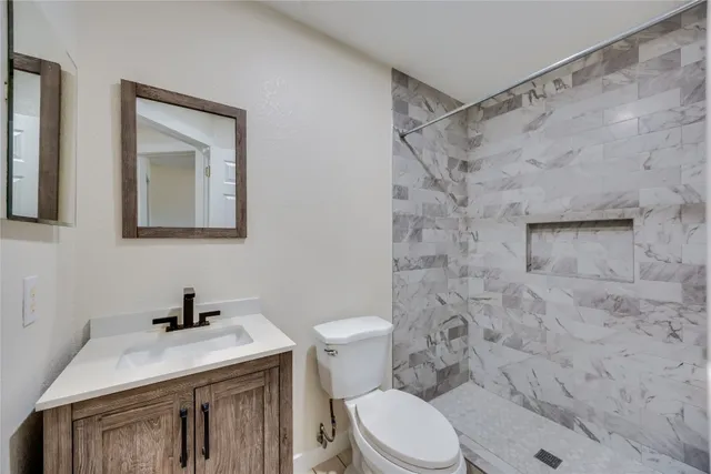 a bathroom with a sink a toilet and a shower