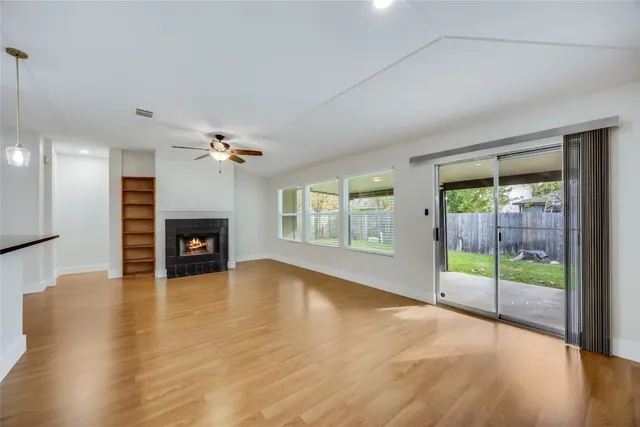 a view of a livingroom with a ceiling fan and window
