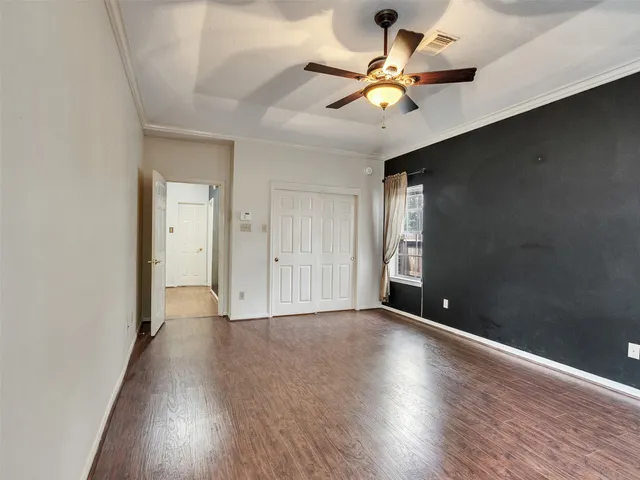 a view of a hallway with wooden floor and staircase