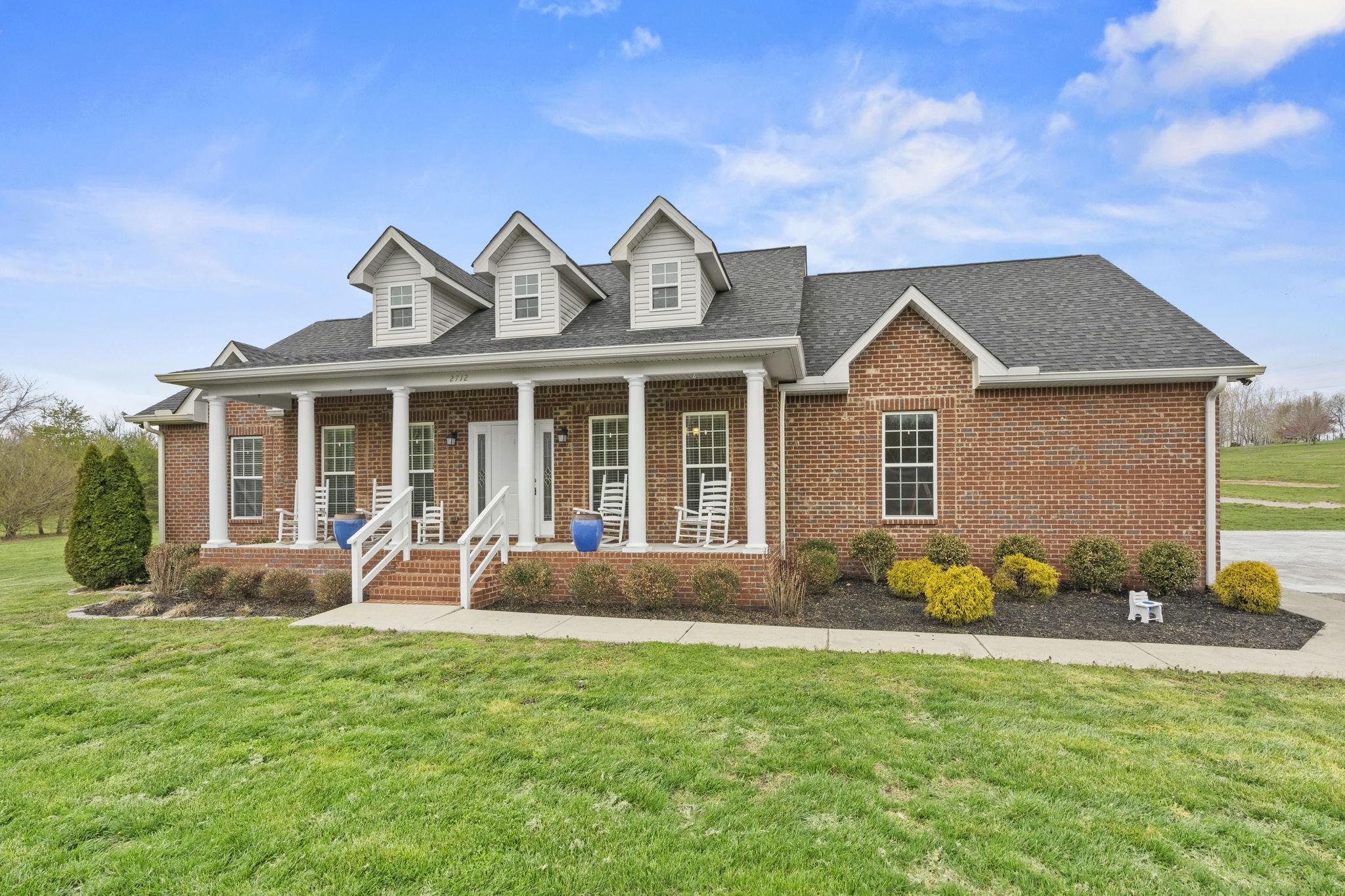 2712 Henry Gower Road Pleasant View, TN 37146 - Photo 1 of 44 a front view of a house with garden