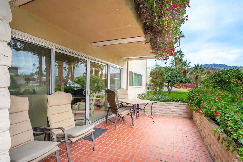 a building outdoor space with patio furniture and potted plants
