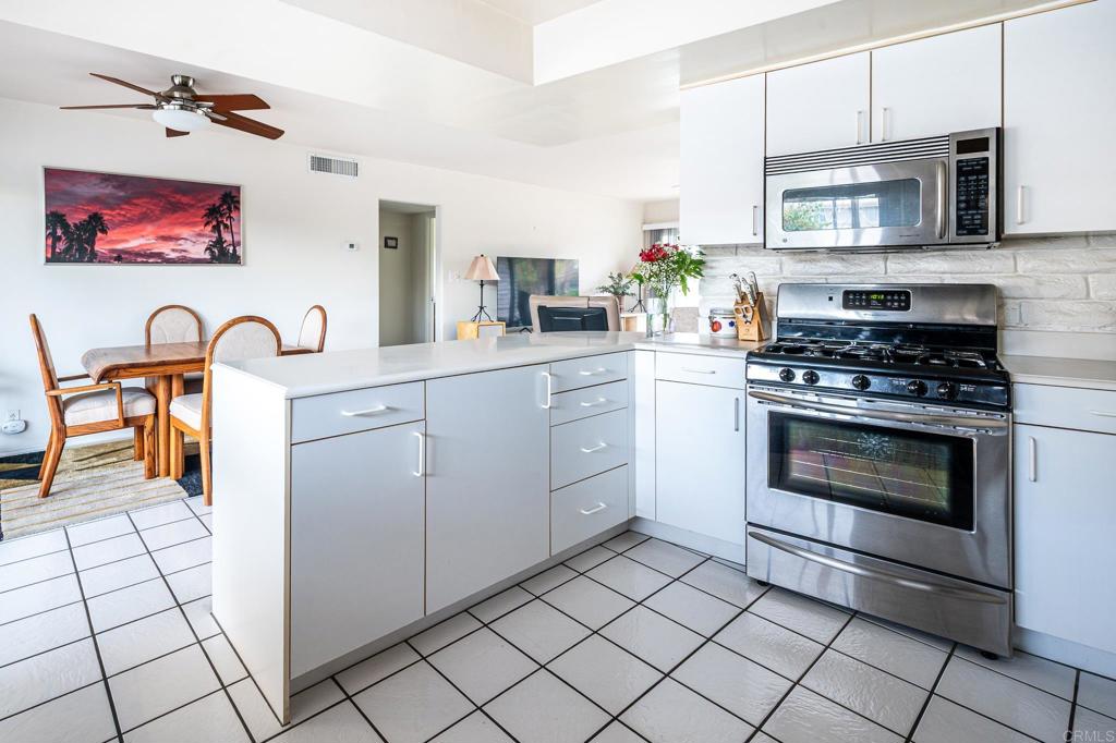 69850 Highway 111, Unit 18 Rancho Mirage, CA 92270 - Photo 13 of 41 a kitchen with stainless steel appliances a stove a sink and a microwave